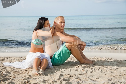 Image of Happy young couple sunbathing