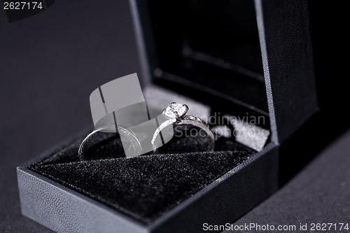 Image of Engagement ring with a bunch of red roses