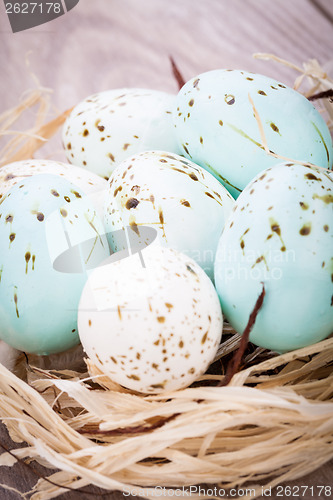 Image of Three natural blue Easter eggs in a basket