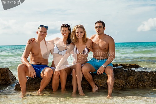 Image of young happy friends havin fun on the beach