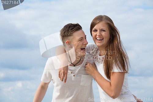 Image of smiling young couple having fun in summer holiday