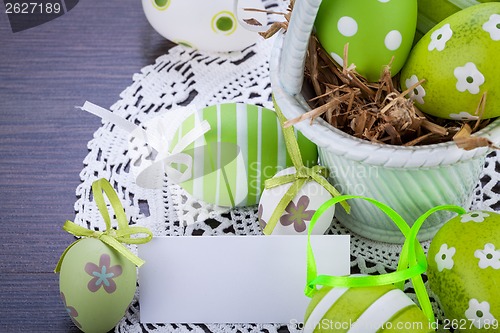 Image of Colourful green Easter eggs in straw