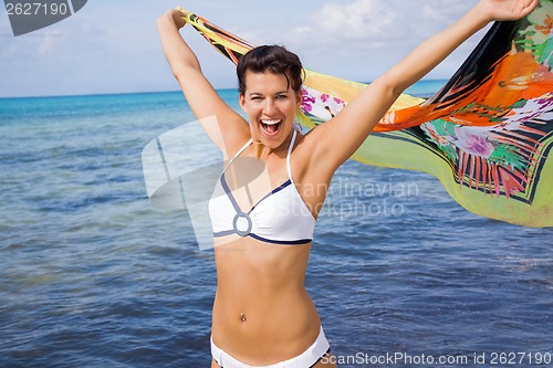 Image of Laughing vivacious woman at the seaside