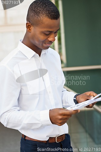 Image of young successful african business man outdoor in summer