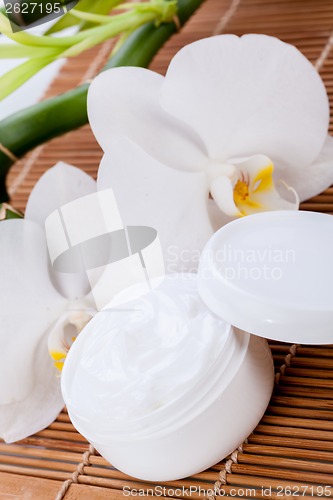 Image of cosmetic face cream on wooden background 