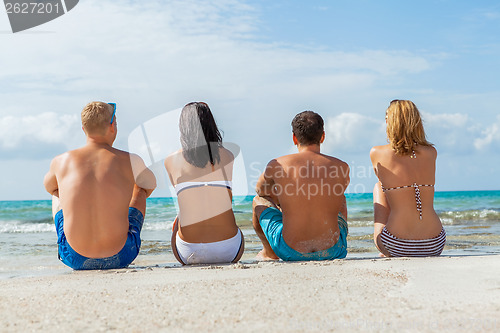 Image of young happy friends havin fun on the beach