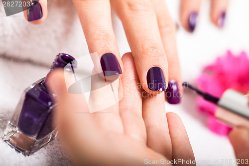 Image of Woman having a nail manicure in a beauty salon