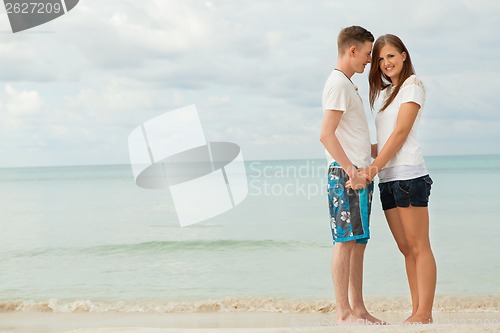 Image of happy young couple on the beach in summer holiday love