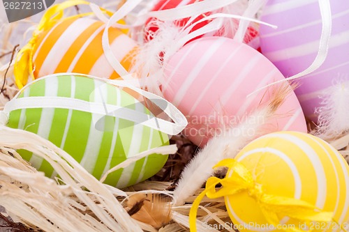 Image of colorful easter egg decoration on wooden background