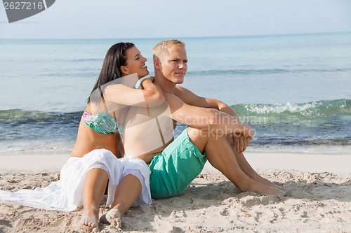 Image of Happy young couple sunbathing