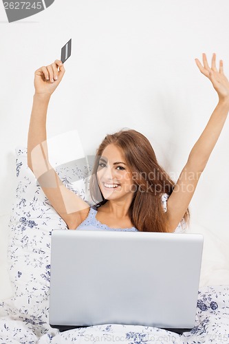 Image of Beautiful woman doing online shopping