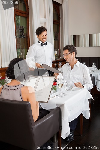 Image of young smiling couple at the restaurant 