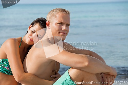 Image of Happy young couple sunbathing