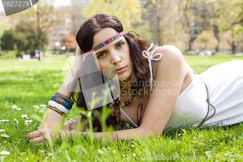 Image of Pretty young woman in a headband daydreaming