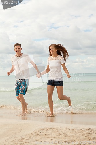 Image of happy young couple on the beach in summer holiday love