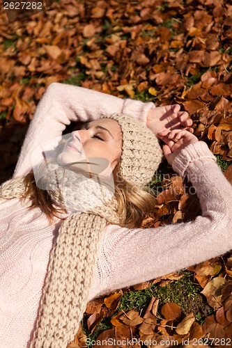 Image of young smiling woman with hat and scarf outdoor in autumn