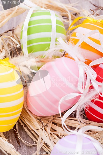 Image of colorful easter egg decoration on wooden background