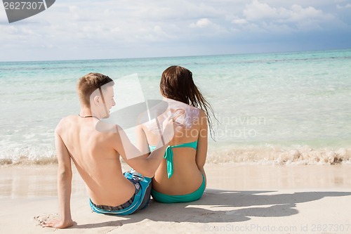 Image of Man drawing a heart on his girlfriends back