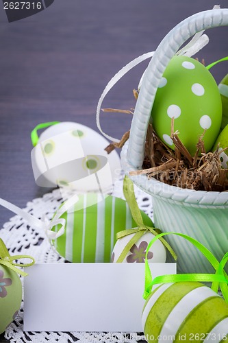 Image of Colourful green Easter eggs in straw