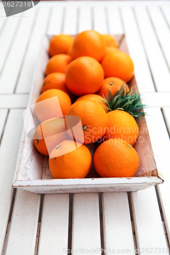 Image of fresh orange fruits decorative on table in summer