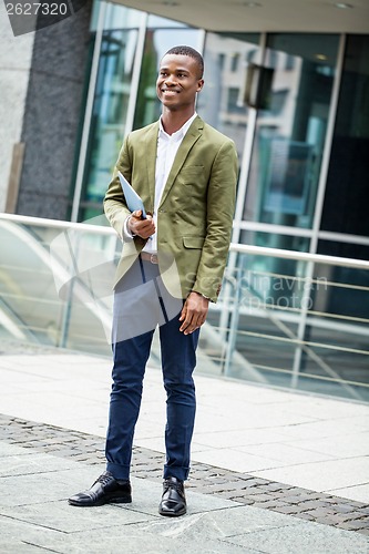 Image of young successful african business man outdoor in summer