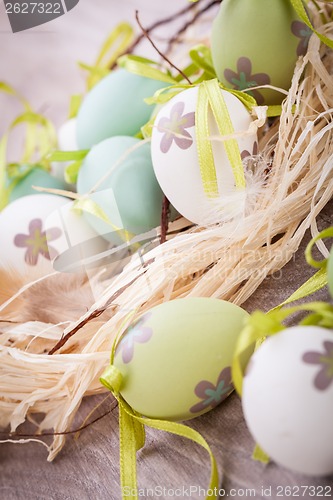 Image of Colourful green Easter eggs in straw