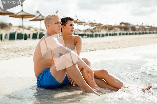 Image of Happy young couple sunbathing