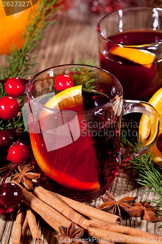 Image of hot tasty spicy mulled red wine with orange and cinnamon christmas 