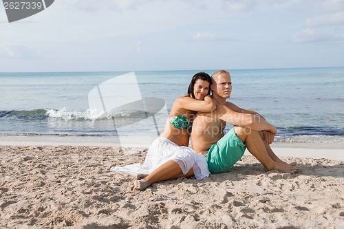 Image of Happy young couple sunbathing