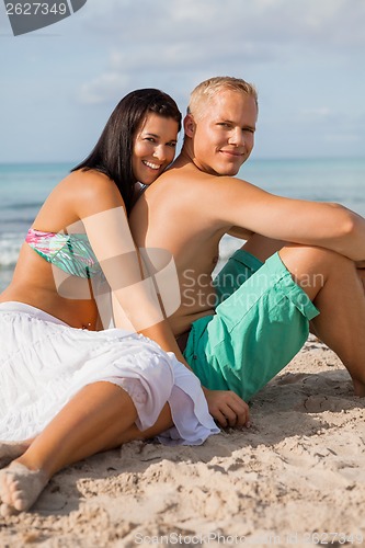 Image of Happy young couple sunbathing