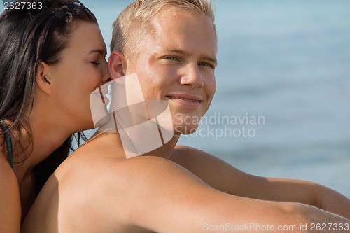 Image of Happy young couple sunbathing