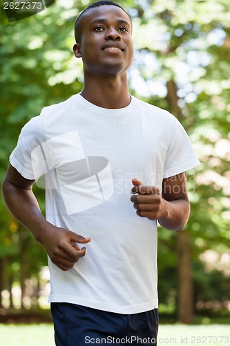 Image of young african athletic runner jogger in park