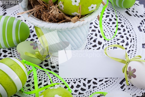 Image of Colourful green Easter eggs in straw