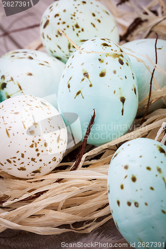 Image of Three natural blue Easter eggs in a basket