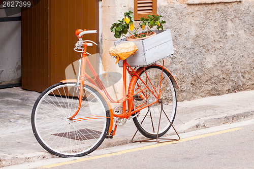 Image of orange ladies bicycle with flowers decoration