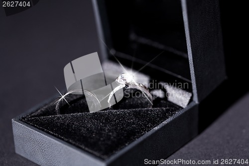 Image of Engagement ring with a bunch of red roses