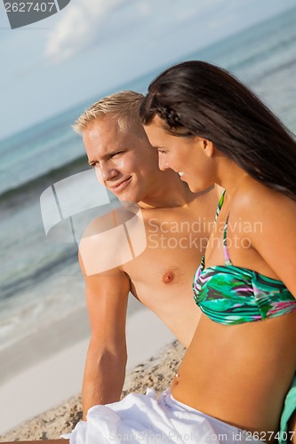 Image of Happy young couple sunbathing