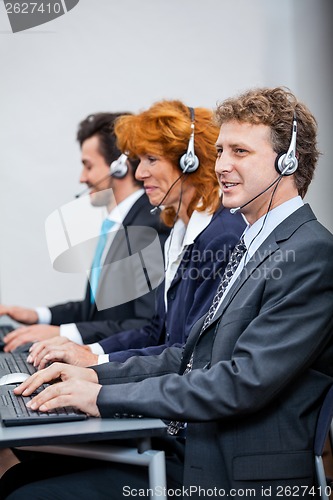 Image of friendly callcenter agent operator with headset telephone 