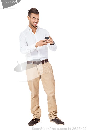 Image of Handsome man reading a message on his mobile