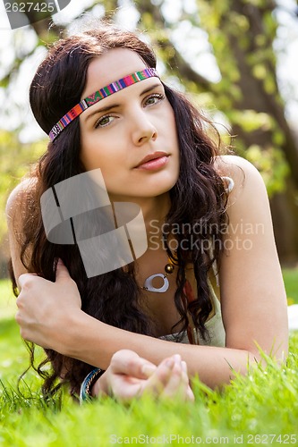 Image of Pretty young woman in a headband daydreaming