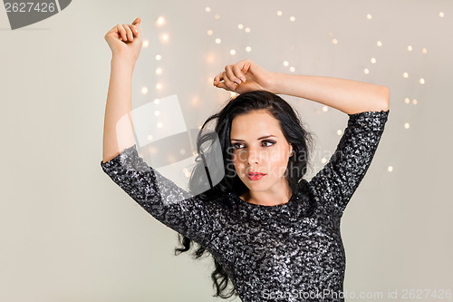 Image of Beautiful dreamy woman with glitter dress dancing