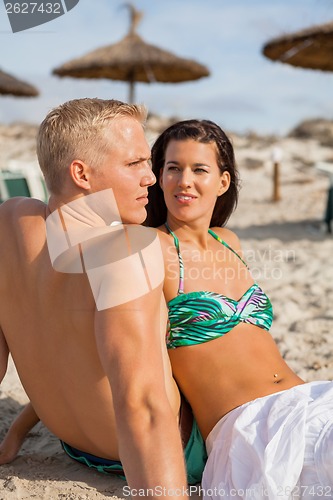 Image of Happy young couple sunbathing