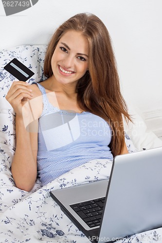 Image of Beautiful woman doing online shopping