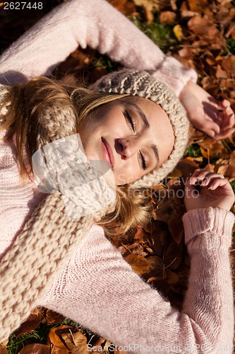 Image of young smiling woman with hat and scarf outdoor in autumn