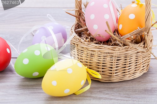 Image of colorful easter egg decoration on wooden background