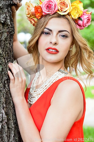 Image of beautiful woman portrait outdoor with colorful flowers