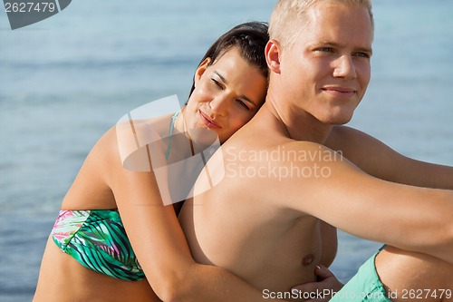 Image of Happy young couple sunbathing