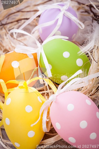 Image of colorful easter egg decoration on wooden background
