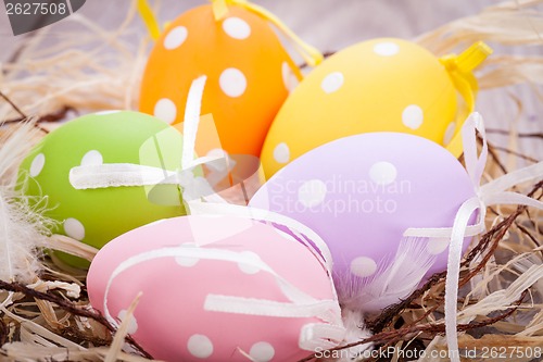 Image of colorful easter egg decoration on wooden background