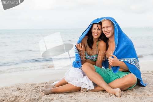 Image of Cheerful couple with a towel covering their heads